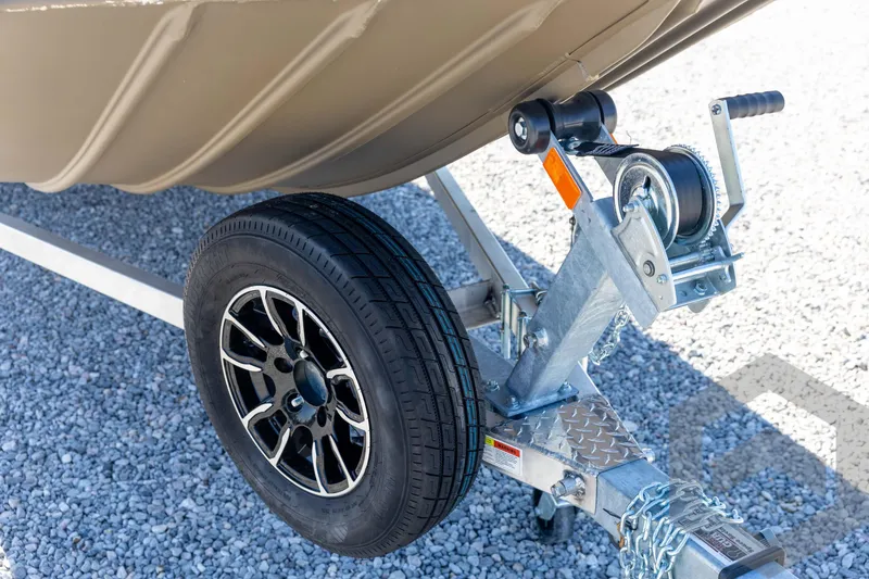 Slide: The Image of Trailer wheel and winch of 2026 G3 Gator Tough 1860 VBW boat on gravel. - 10