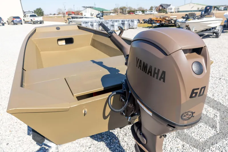 Slide: The Image of 2026 G3 Gator Tough 1860 VBW boat with Yamaha 60 outboard motor in a gravel lot. - 16