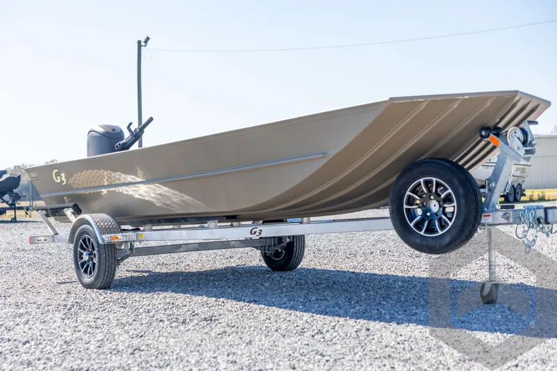 Slide: The Image of 2026 G3 Gator Tough 1860 VBW boat on trailer, parked on gravel. - 3
