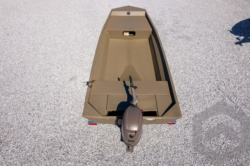 Slide: The Image of 2026 G3 Gator Tough 1860 VBW boat on gravel, top view, with outboard motor. - 31