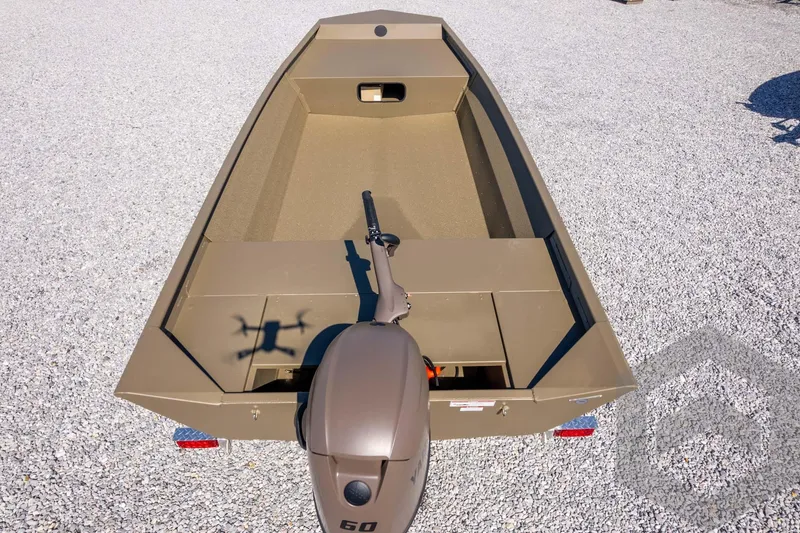 Slide: The Image of 2026 G3 Gator Tough 1860 VBW boat on gravel, featuring a 60 HP motor. - 36