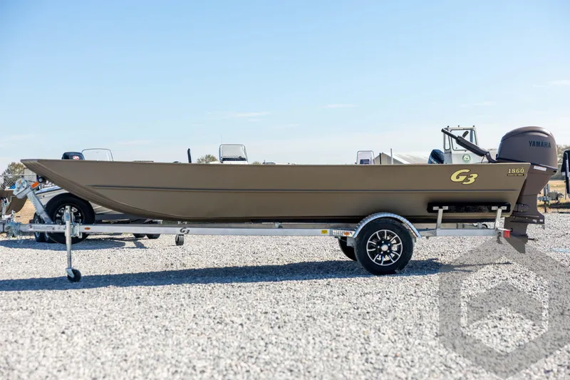 Slide: The Image of 2026 G3 Gator Tough 1860 VBW boat on trailer, side view, outdoors. - 8