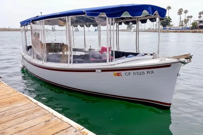 Slide: The Image of Steering wheel of a 2014 Duffy 22 Bay Island boat, overlooking a marina. - 9