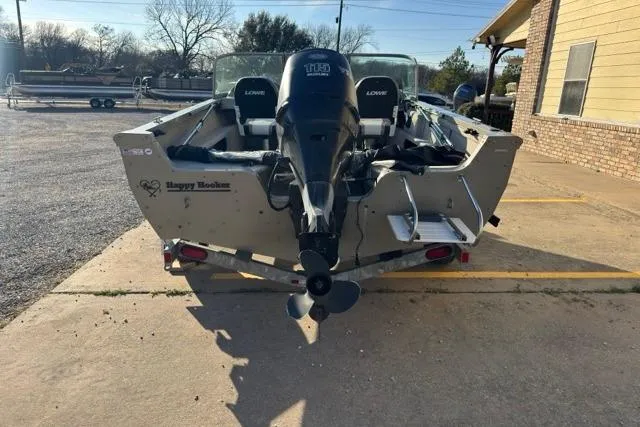 Slide: The Image of 2007 Lowe Fish & Ski 175 boat with motor, parked outdoors on concrete. - 10