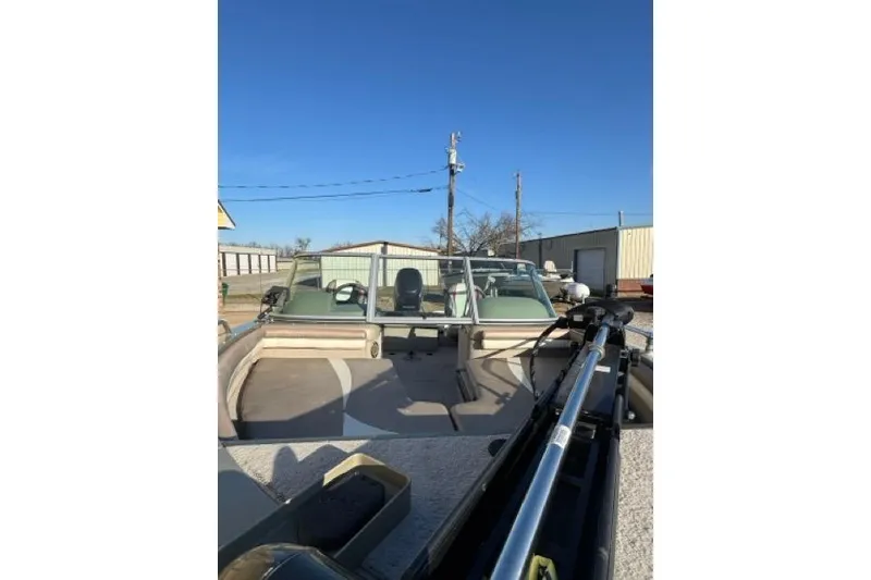 Slide: The Image of 2007 Lowe Fish & Ski 175 boat with seating and equipment, parked outdoors under clear blue sky. - 3