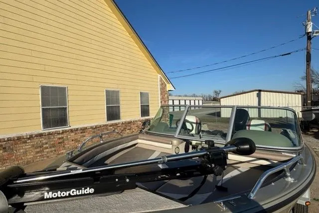 Slide: The Image of 2007 Lowe Fish & Ski 175 boat with MotorGuide, parked near a yellow building. - 4