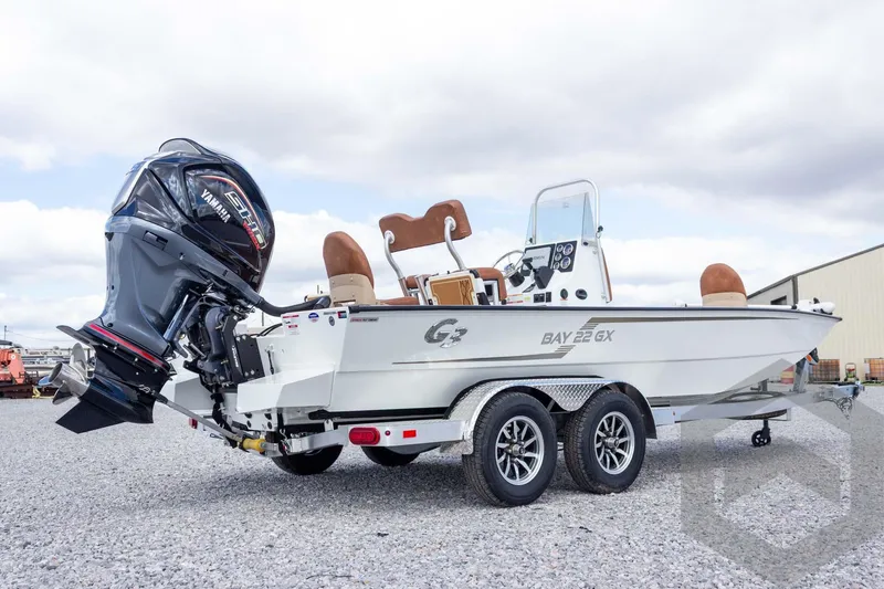 Slide: The Image of 2026 G3 Bay 22 GX boat on trailer with Yamaha outboard motor, parked on gravel. - 17