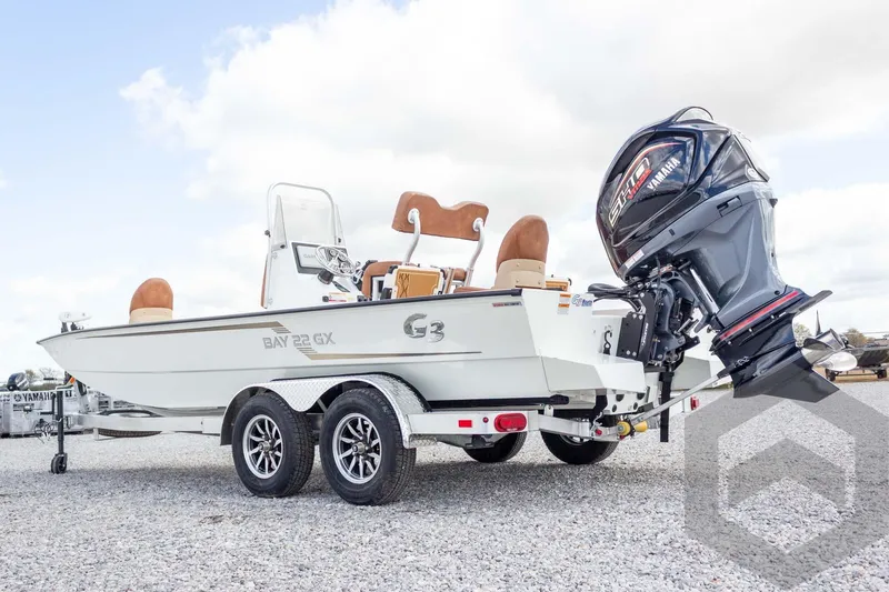 Slide: The Image of 2026 G3 Bay 22 GX boat on trailer with Yamaha outboard motor, parked on gravel. - 19