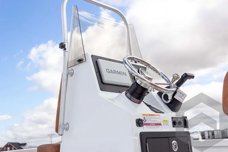 Slide: The Image of 2026 G3 Bay 22 GX boat console with Garmin navigation, steering wheel, and throttle controls. - 25