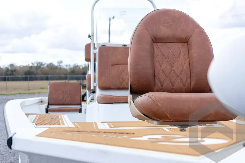 Slide: The Image of 2026 G3 Bay 22 GX boat with luxurious brown leather seating and sleek design. - 29