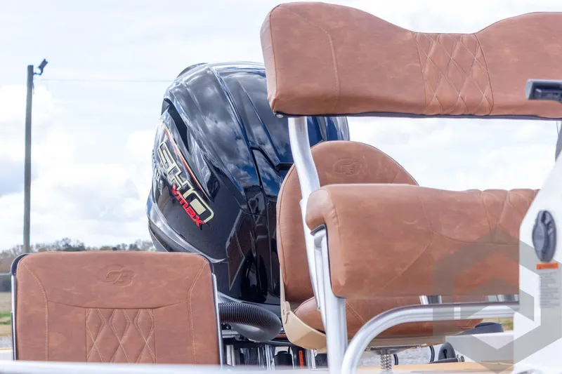 Slide: The Image of 2026 G3 Bay 22 GX boat with brown leather seats and powerful engine. - 30