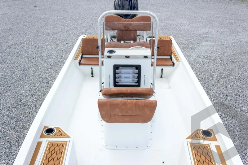 Slide: The Image of 2026 G3 Bay 22 GX boat interior with brown seating and center console. - 38