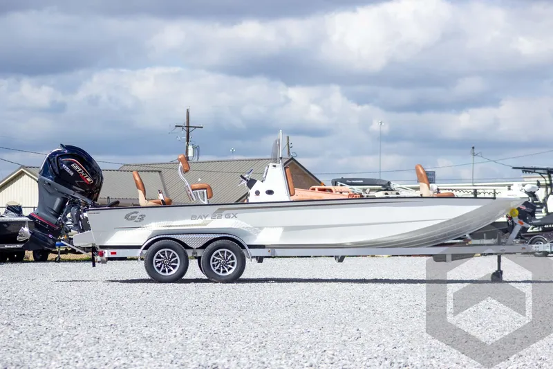 Slide: The Image of 2026 G3 Bay 22 GX boat on trailer, outdoor display, cloudy sky background. - 4