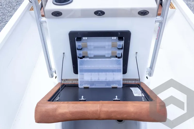 Slide: The Image of 2026 G3 Bay 22 GX boat storage compartment with tackle boxes and leather trim. - 40