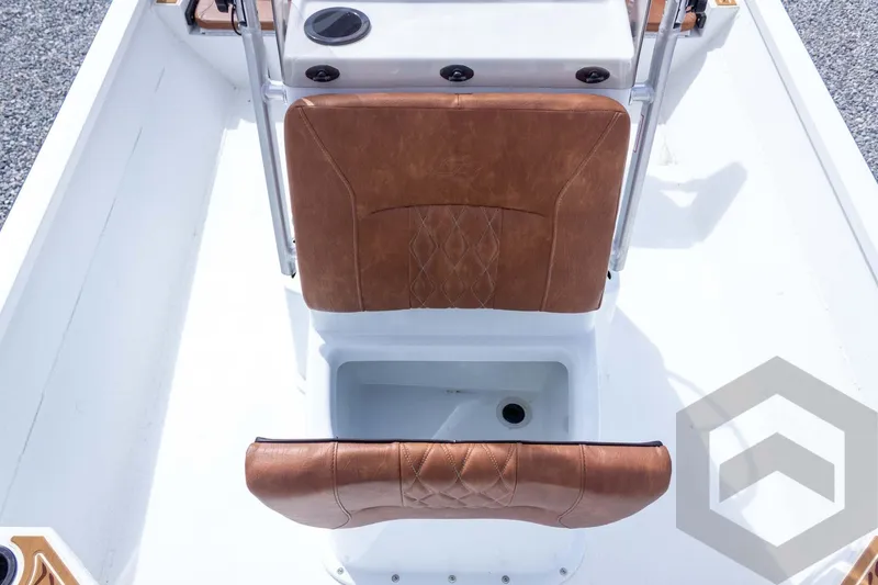 Slide: The Image of 2026 G3 Bay 22 GX boat interior with brown leather seating and storage compartment. - 41