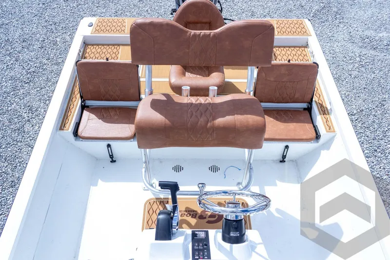 Slide: The Image of 2026 G3 Bay 22 GX boat interior with brown seating and steering wheel. - 42