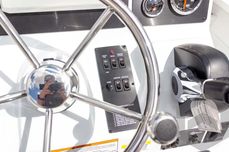Slide: The Image of 2026 G3 Bay 22 GX boat dashboard with steering wheel and control panel. - 46