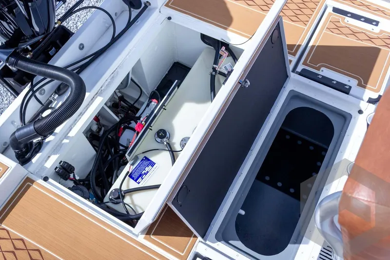 Slide: The Image of Open compartments of 2026 G3 Bay 22 GX boat showing internal wiring and storage. - 52