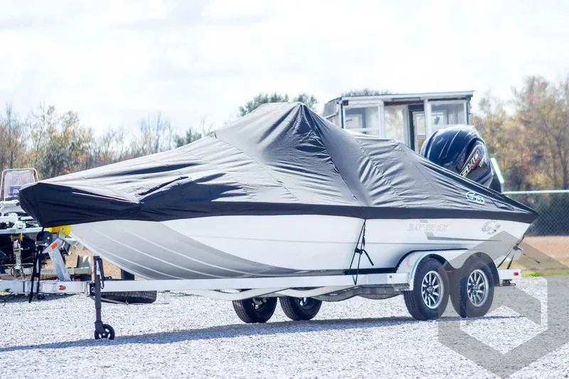 Slide: The Image of 2026 G3 Bay 22 GX boat covered on trailer, parked outdoors. - 55