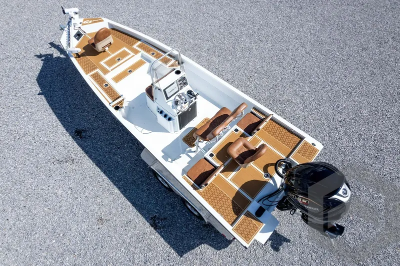 Slide: The Image of 2026 G3 Bay 22 GX boat with brown seating and Yamaha outboard motor. - 58
