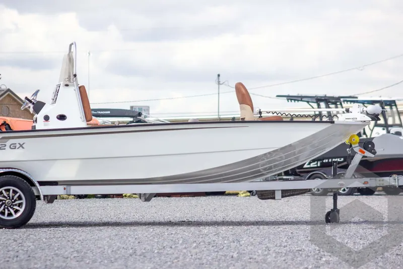 Slide: The Image of 2026 G3 Bay 22 GX boat on trailer, parked outdoors. - 6