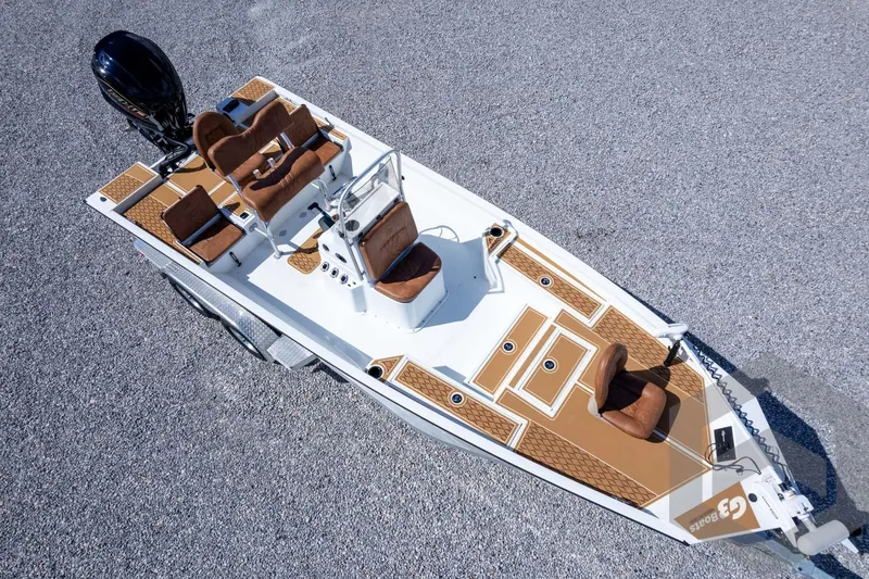 Slide: The Image of 2026 G3 Bay 22 GX boat with brown seating and sleek design on a trailer. - 62