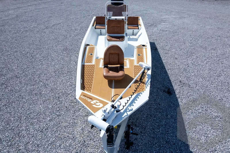 Slide: The Image of 2026 G3 Bay 22 GX boat with brown seating on gravel surface. - 66