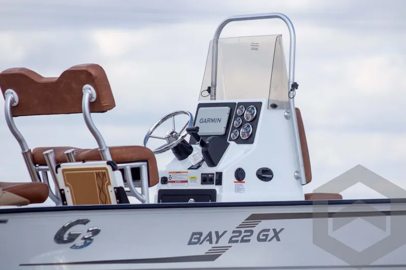 Slide: The Image of 2026 G3 Bay 22 GX boat console with Garmin navigation system and brown seating. - 8