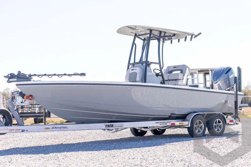 The Image of 2026 Pathfinder 2500 Hybrid boat on trailer, sleek design, outdoor setting. - 1