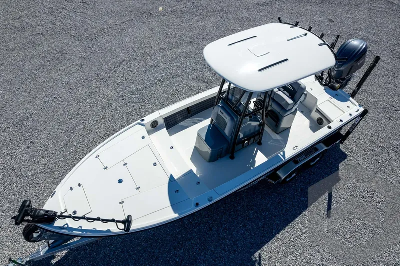 Slide: The Image of 2026 Pathfinder 2500 Hybrid boat on gravel, featuring sleek design and modern amenities. - 105