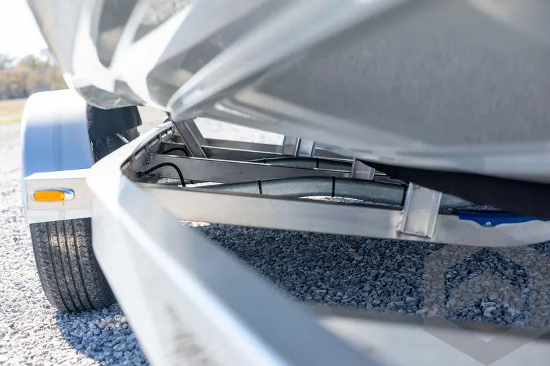 Slide: The Image of Underneath view of 2026 Pathfinder 2500 Hybrid boat trailer on gravel surface. - 14