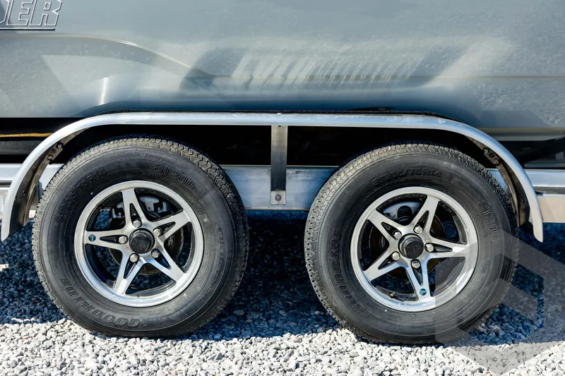 Slide: The Image of 2026 Pathfinder 2500 Hybrid trailer wheels on gravel surface. - 15