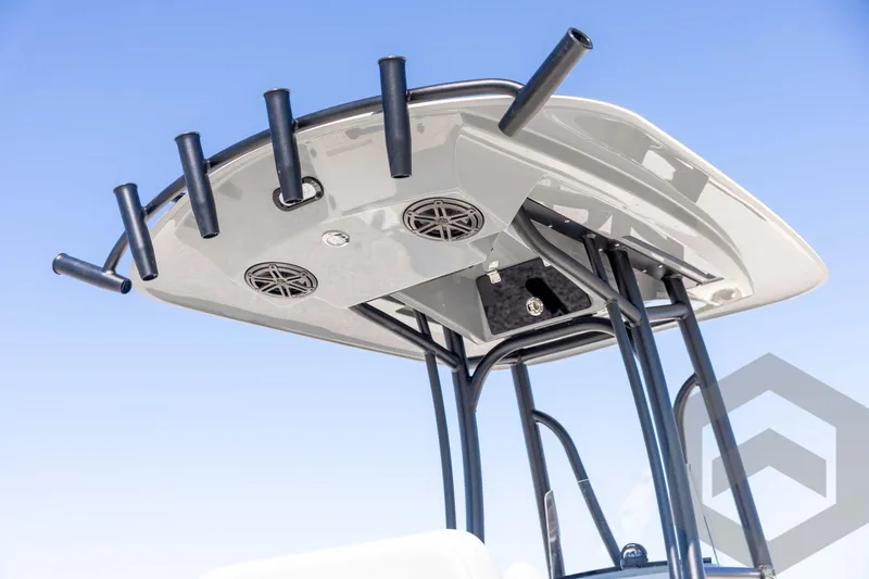 Slide: The Image of 2026 Pathfinder 2500 Hybrid boat T-top with rod holders and speakers against blue sky. - 17