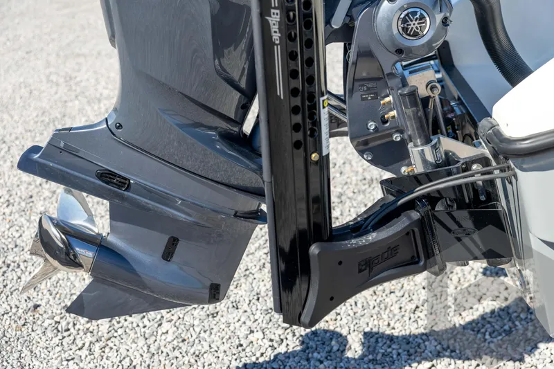 Slide: The Image of Close-up of a 2026 Pathfinder 2500 Hybrid boat motor and propeller on gravel. - 21