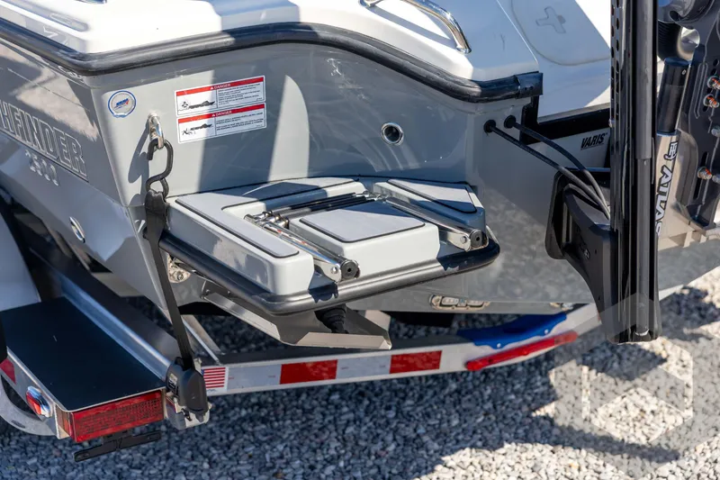 Slide: The Image of 2026 Pathfinder 2500 Hybrid boat rear view with trailer, showcasing step platform and safety labels. - 29