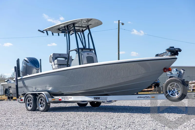 Slide: The Image of 2026 Pathfinder 2500 Hybrid boat on trailer, parked outdoors under clear sky. - 3