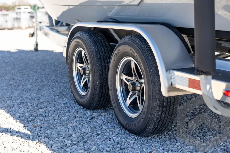 Slide: The Image of 2026 Pathfinder 2500 Hybrid trailer wheels on gravel surface. - 35