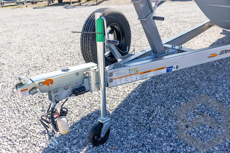 Slide: The Image of Trailer hitch and wheel assembly on gravel, Pathfinder 2500 Hybrid, 2026 model. - 45
