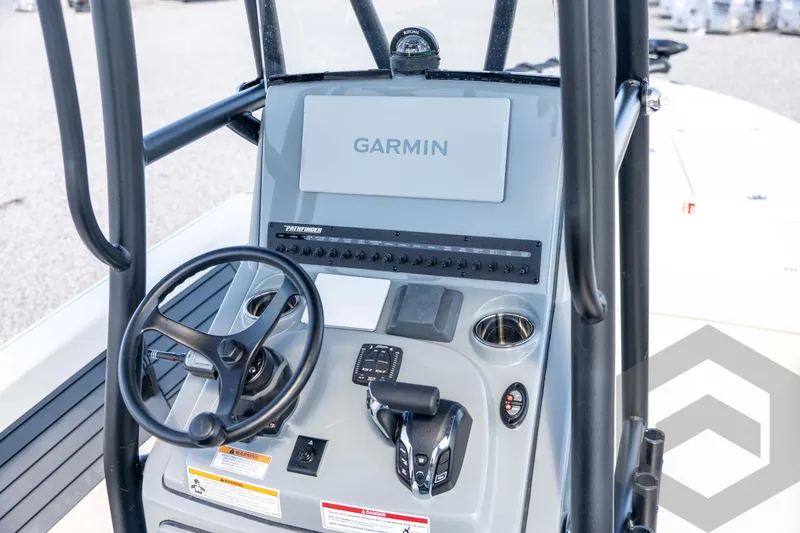 Slide: The Image of 2026 Pathfinder 2500 Hybrid boat console with Garmin navigation system and steering wheel. - 67