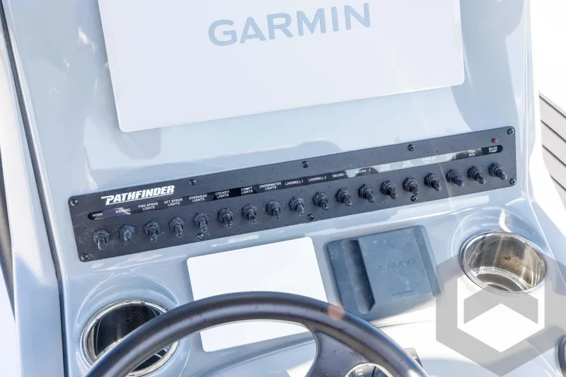 Slide: The Image of Control panel of 2026 Pathfinder 2500 Hybrid boat with Garmin display and switches. - 72