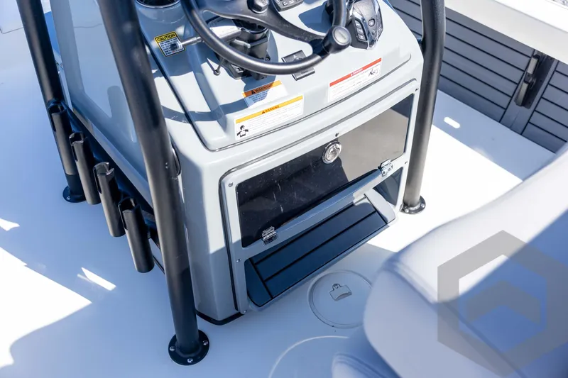 Slide: The Image of 2026 Pathfinder 2500 Hybrid boat console with steering wheel and storage compartment. - 75
