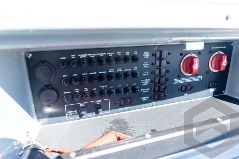 Slide: The Image of Control panel of 2026 Pathfinder 2500 Hybrid boat with switches and power outlets. - 76