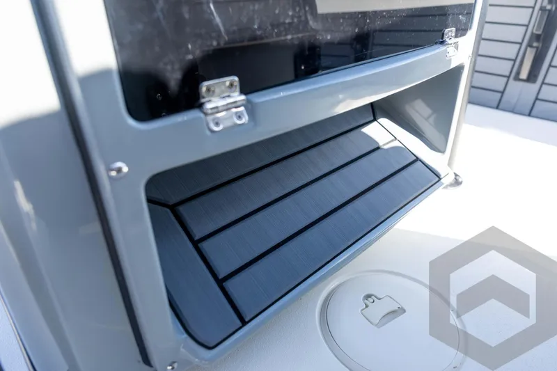 Slide: The Image of 2026 Pathfinder 2500 Hybrid boat storage compartment with sleek design and secure latch. - 77