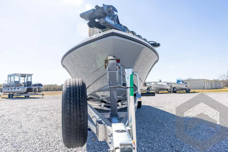 Slide: The Image of 2026 Pathfinder 2500 Hybrid boat on trailer, parked on gravel lot under clear sky. - 9