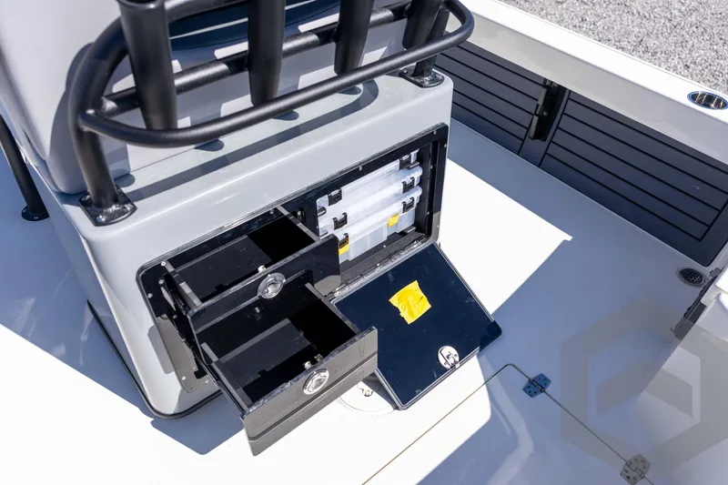 Slide: The Image of 2026 Pathfinder 2500 Hybrid boat storage compartments with open drawers and tackle boxes. - 96