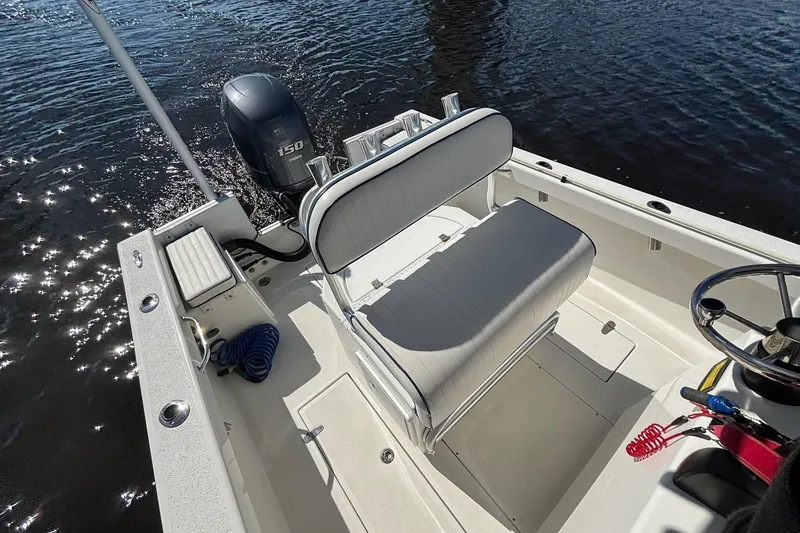 Slide: The Image of 2015 KenCraft BreakWater 20 boat interior with seating and Yamaha 150 engine on water. - 15