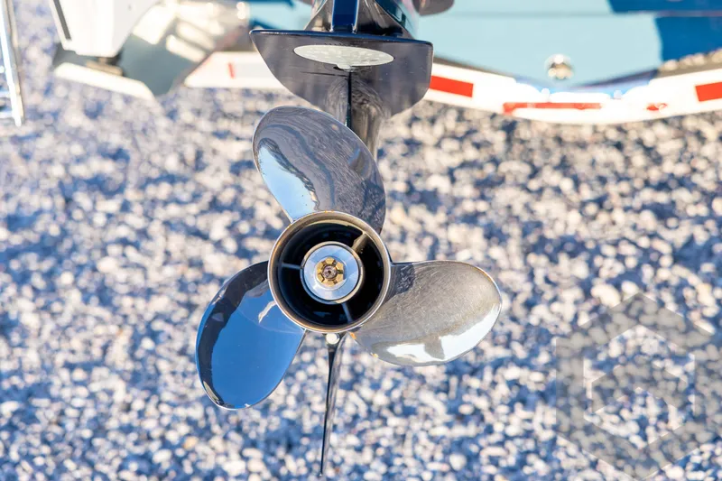 Slide: The Image of Close-up of a 2026 Tidewater 2110 Bay Max boat propeller on gravel. - 16