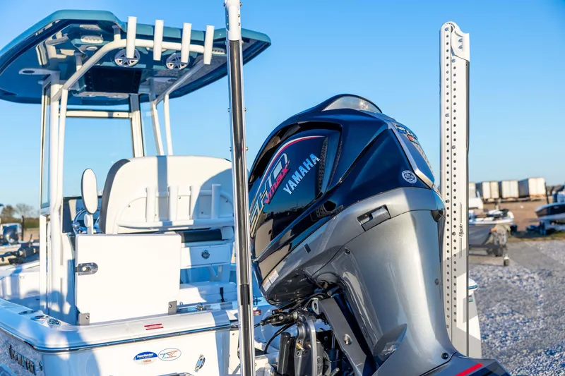 Slide: The Image of 2026 Tidewater 2110 Bay Max boat with Yamaha engine, docked under clear blue sky. - 24