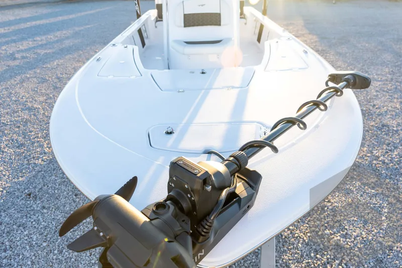 Slide: The Image of 2026 Tidewater 2110 Bay Max boat with trolling motor on gravel surface. - 35