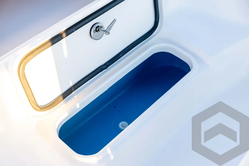 Slide: The Image of 2026 Tidewater 2110 Bay Max boat storage compartment with open lid and blue interior. - 40